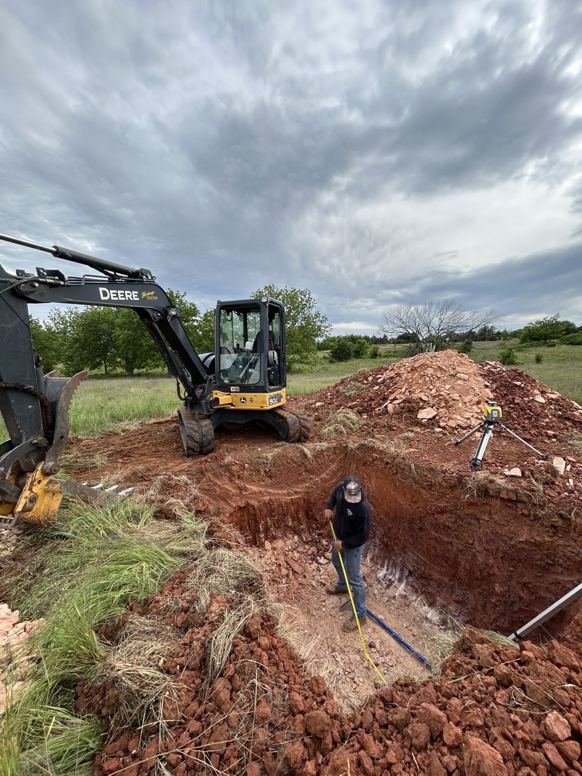 Excavator digging for a new septic system install